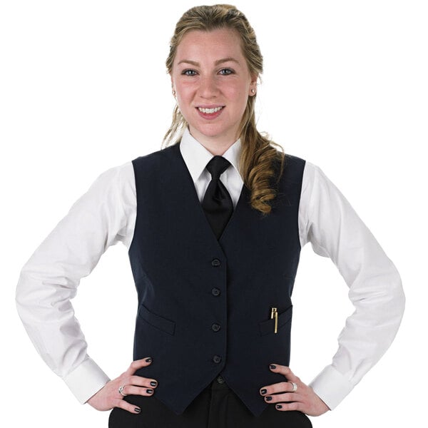 A woman wearing a navy blue Henry Segal server vest and tie.
