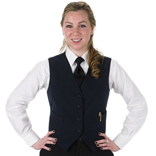 A woman wearing a Henry Segal navy blue server vest and tie.