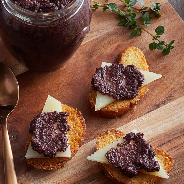 A piece of bread with Dalmatia Black Olive Spread on top.