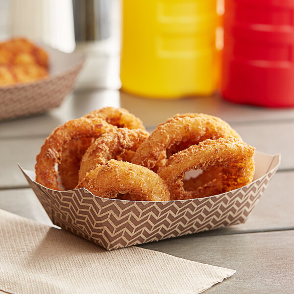 A plate of Carnival King Cornerstone paper food trays filled with fried onion rings.