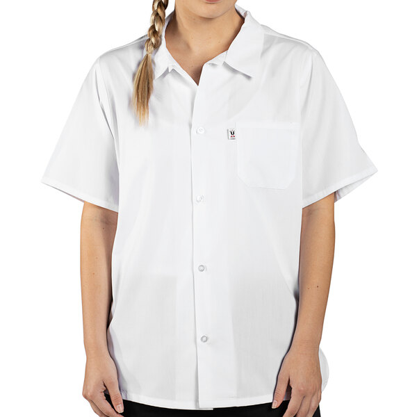 A woman wearing a white Uncommon Chef cook shirt with a mesh back.