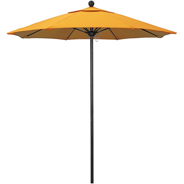 A yellow California Umbrella on a black pole.