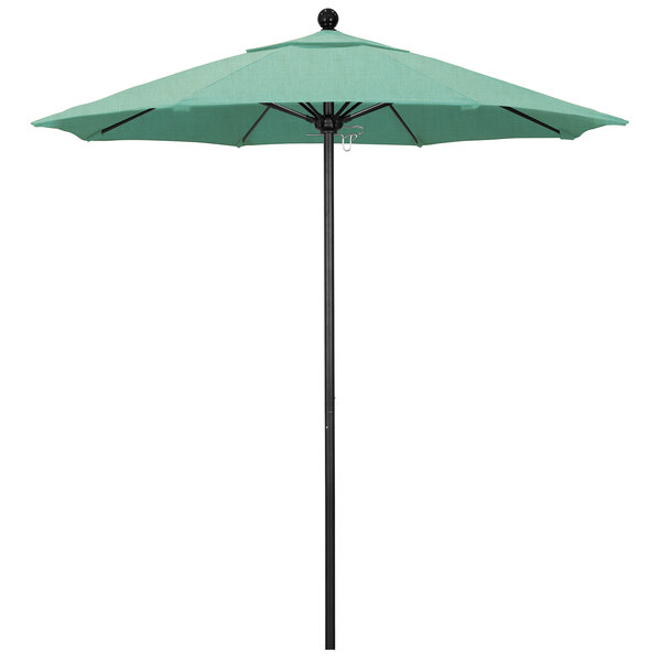 A green California Umbrella with Sunbrella Spectrum Mist fabric on a black pole.