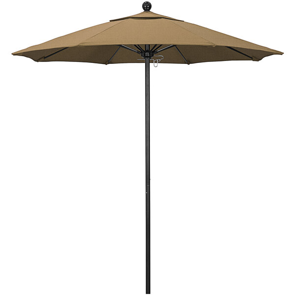 A straw-colored California Umbrella with a black pole on a table.