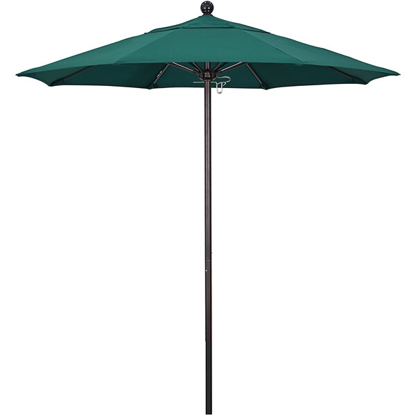 A Hunter Green California Umbrella on a black metal pole.