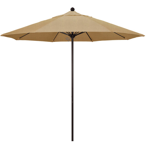 A tan California Umbrella on a pole with a Sunbrella Linen Sesame canopy.