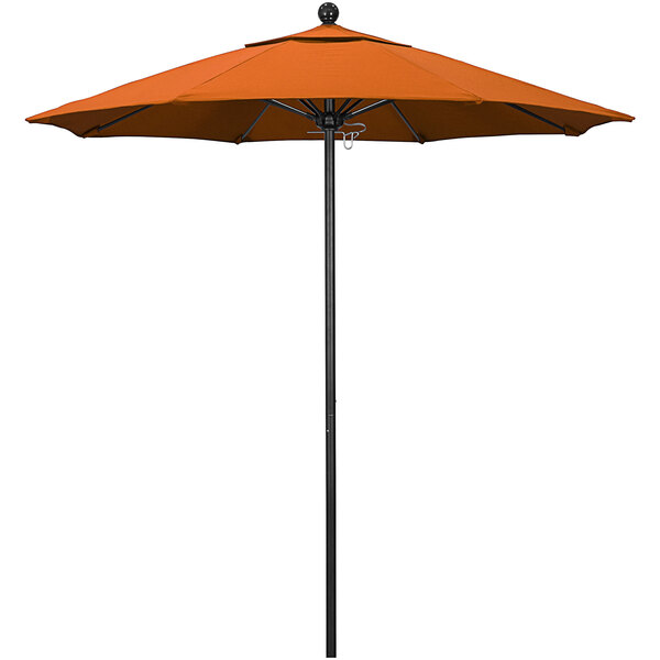An orange California Umbrella with a black pole.