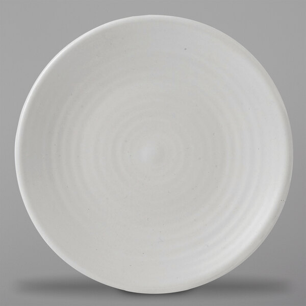 A white Dudson stoneware plate with a spiral design.
