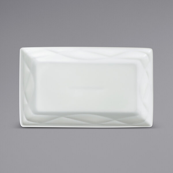 A white rectangular Sant'Andrea Pensato porcelain platter with an embossed wavy design.
