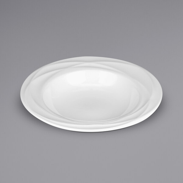 A white porcelain pasta bowl with an embossed wavy rim.