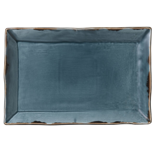 A blue rectangular china platter with brown edges.