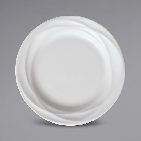 A close up of a Sant'Andrea Pensato bright white porcelain plate with an embossed wavy design.