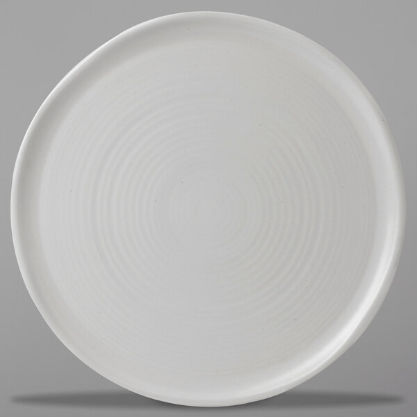 A close up of a Dudson Matte Pearl stoneware plate with a circular pattern on it.