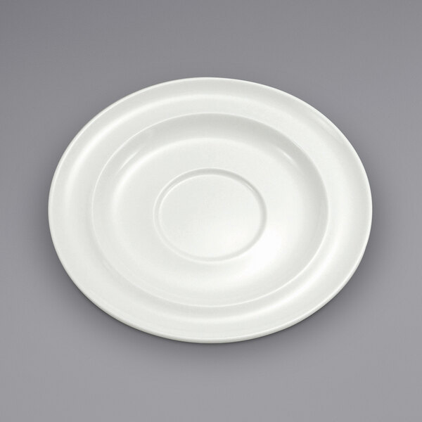 A white porcelain saucer with a wide rim and a circle in the middle.