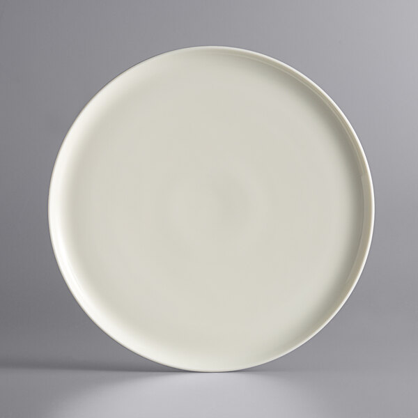 A Luzerne white porcelain coupe plate with a gray speckled rim.