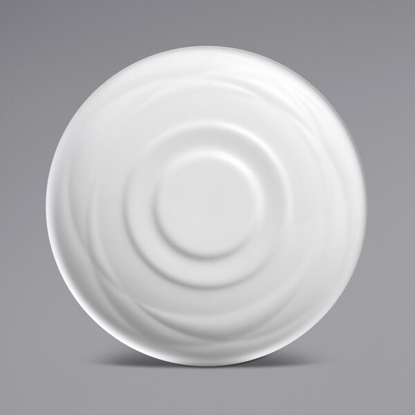 A Sant'Andrea Pensato bright white porcelain saucer with a circular pattern.