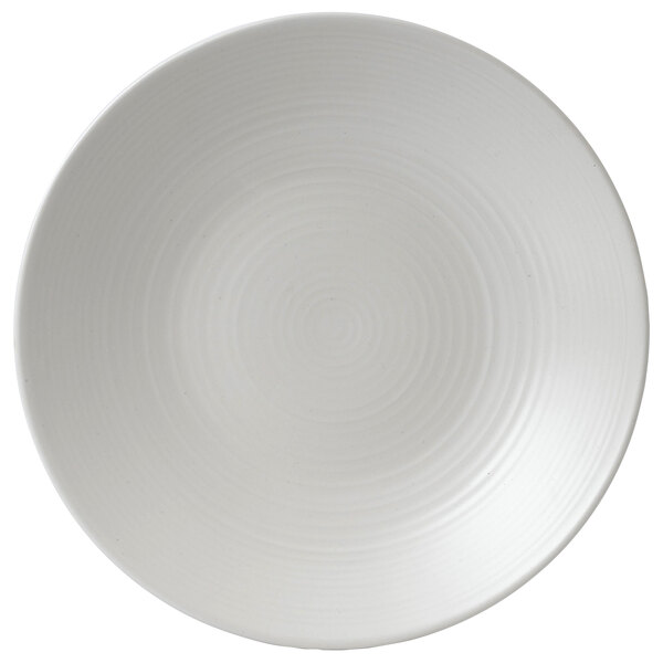 A close-up of a white Dudson Evo stoneware plate with a spiral pattern.