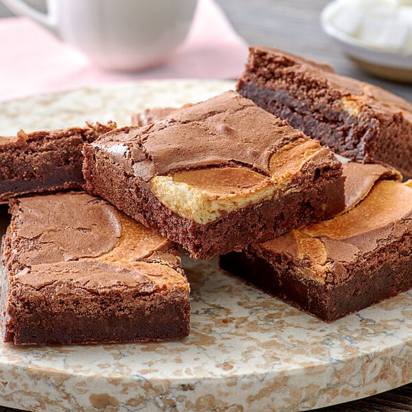 A tray with several David's Cookies cheesecake brownies on a plate.
