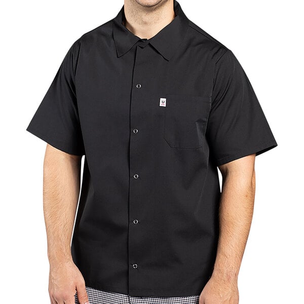 A man wearing a black Uncommon Chef cook shirt.