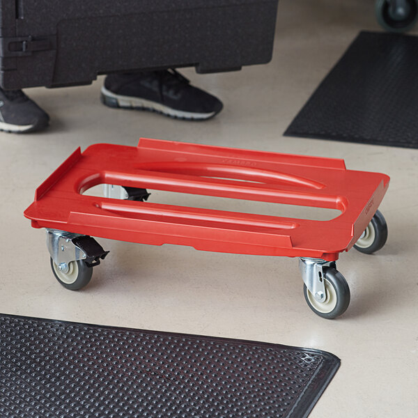 A red Cambro Camdolly for hot food pans.
