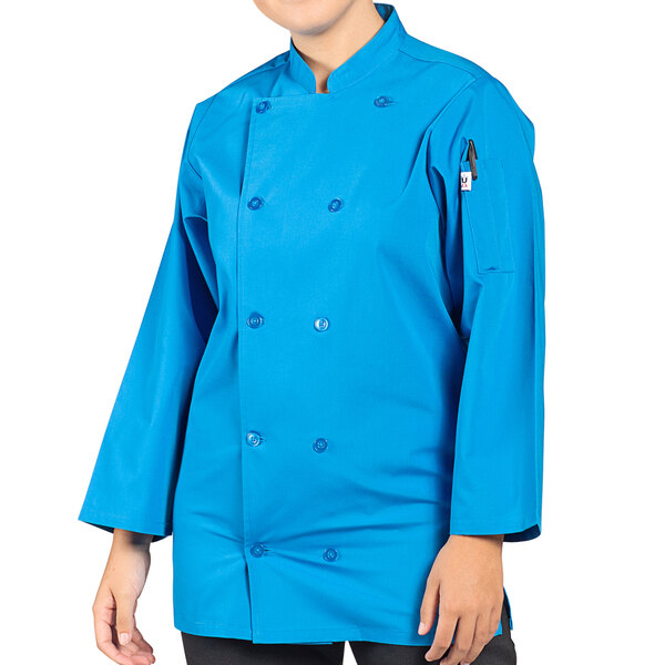 A woman wearing a cobalt blue Uncommon Chef 3/4 sleeve chef coat.