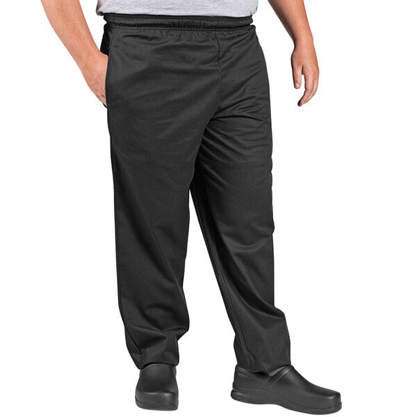 A person wearing Uncommon Chef black traditional chef pants.