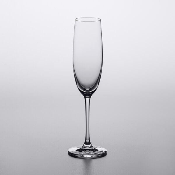 A clear Lucaris Bliss wine glass on a white surface.