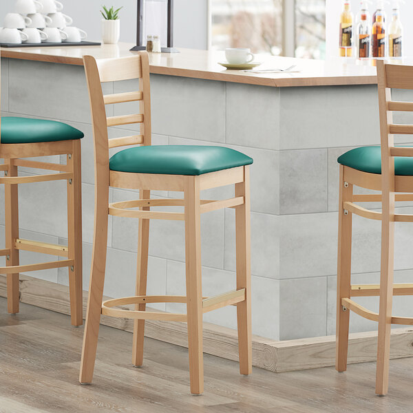 Lancaster Table & Seating Natural Ladder Back Bar Height Chair with 2 1/2" Green Padded Seat