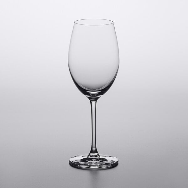A close up of a Lucaris Chardonnay wine glass on a white surface.