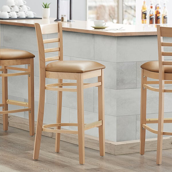 Lancaster Table & Seating Natural Ladder Back Bar Height Chair with 2 1/2" Light Brown Padded Seat