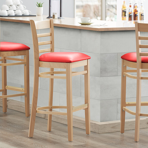 Lancaster Table & Seating Natural Ladder Back Bar Height Chair with 2 1/2" Red Padded Seat