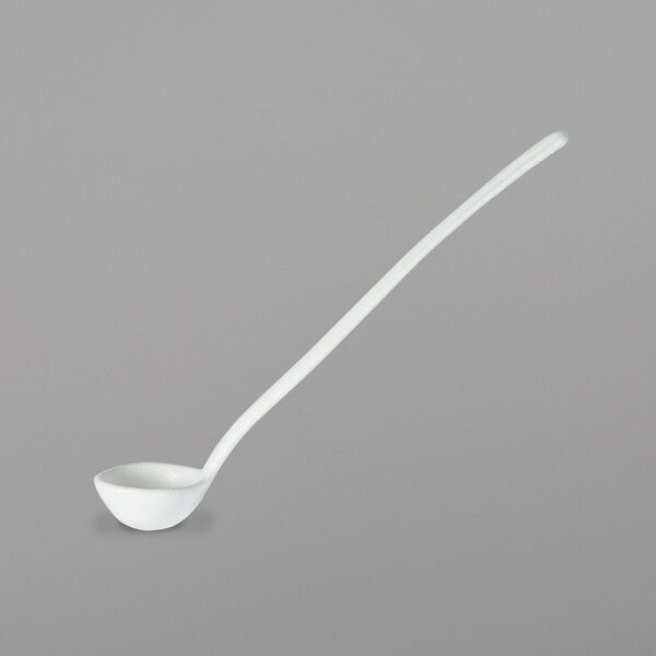 A white ladle with a long handle.
