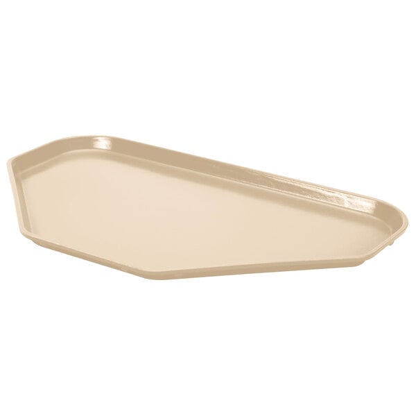 A beige MFG Fiberglass cafeteria tray with a trapezoid shape.