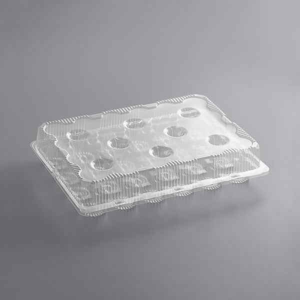 A clear plastic Choice cupcake container with holes in it.