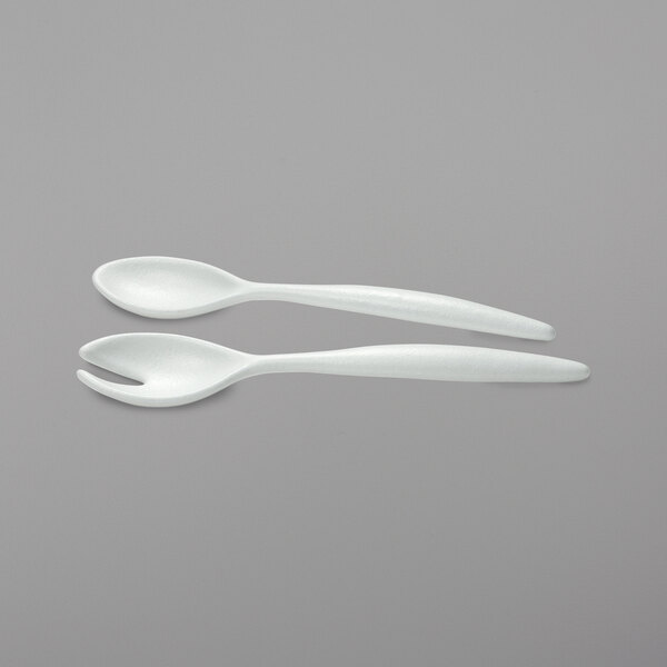 A pair of white resin-coated aluminum salad servers with spoon and fork ends.