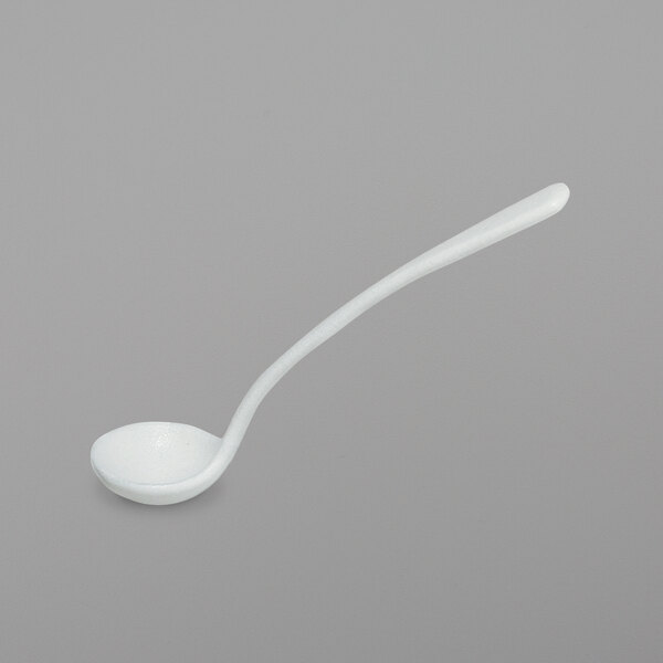 A white ladle with a long handle.