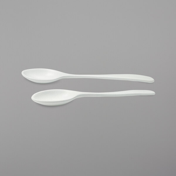 Two G.E.T. Enterprises Bugambilia server spoons with white handles.