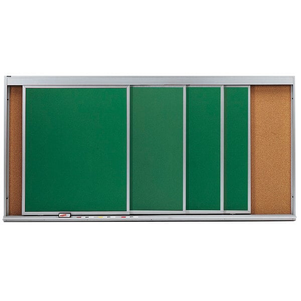 A green cork board with white trim and horizontal sliding chalk boards.
