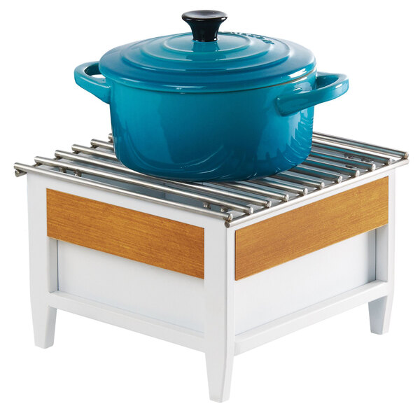 A blue pot with a lid on a white and wood Cal-Mil Monterey chafer alternative stand.