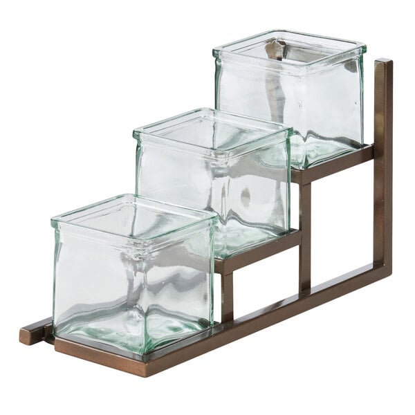 A Cal-Mil Sierra Bronze 3 Step Jar Display with glass containers on a metal stand.