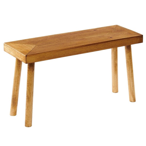 A Cal-Mil Madera rustic pine wood riser with angled legs on a table.