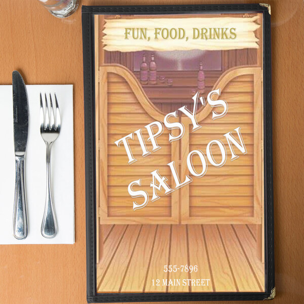 A table with a Southwest themed saloon menu and silverware.