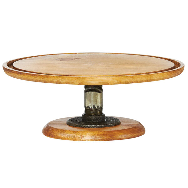 A wooden Cal-Mil Madera cake stand with a metal base.