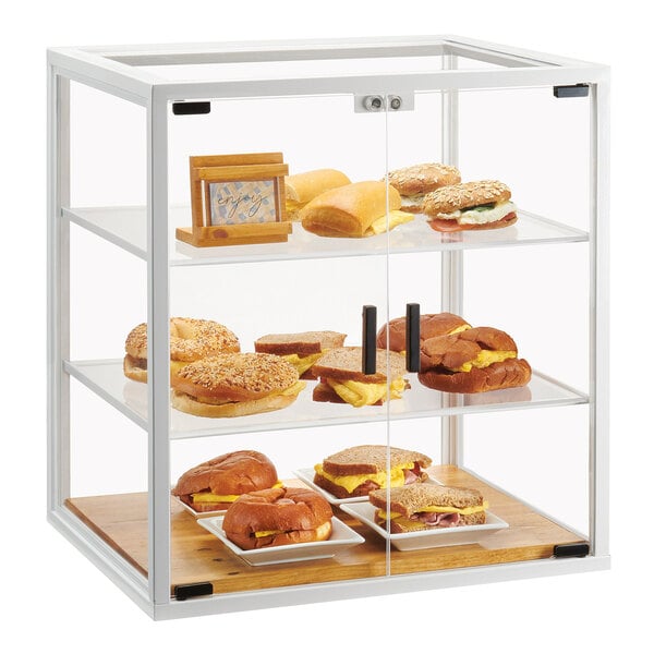 A white Cal-Mil bakery display case with food inside.