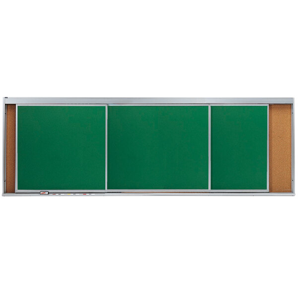 A green cork board with white horizontal sliding chalk boards.