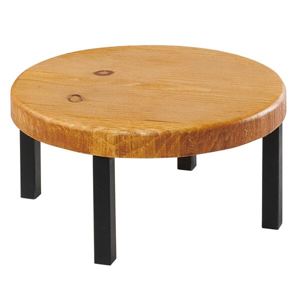 A Cal-Mil rustic round wood riser on a round wooden table with black legs.