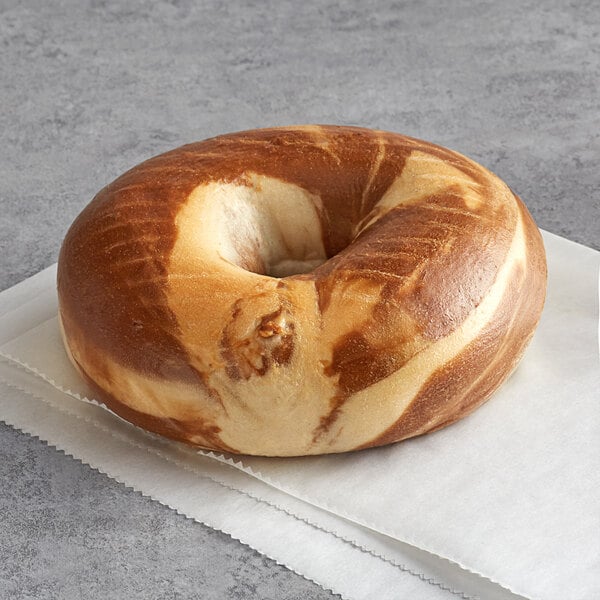 An Original Bagel marble bagel with a hole in the middle on a napkin.