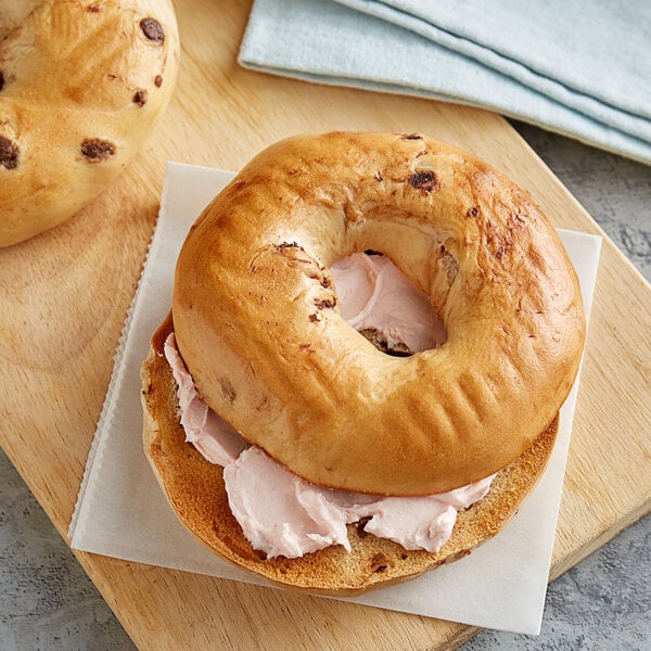Two Original New York Style Chocolate Chip Bagels with cream cheese on top.