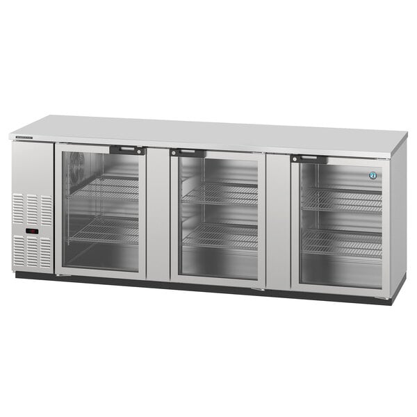 A stainless steel Hoshizaki back bar refrigerator with three glass doors.