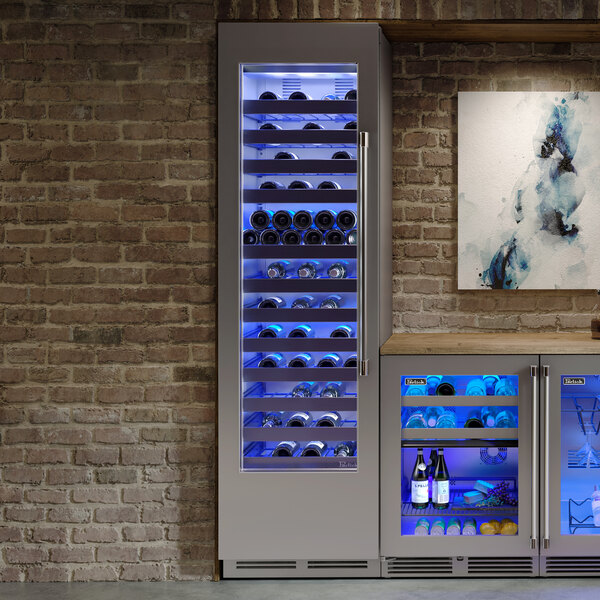 A Perlick wine refrigerator with bottles of wine on shelves behind a glass door.